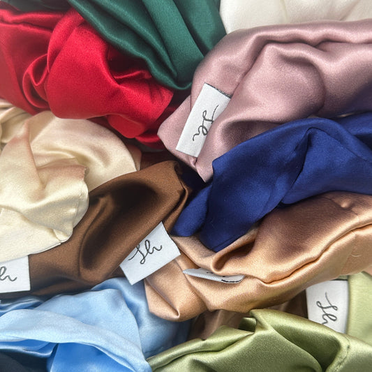 A photo showcasing the entire range of colours for the Síoda Silky 100% Mulberry silk scrunchies, large sizes