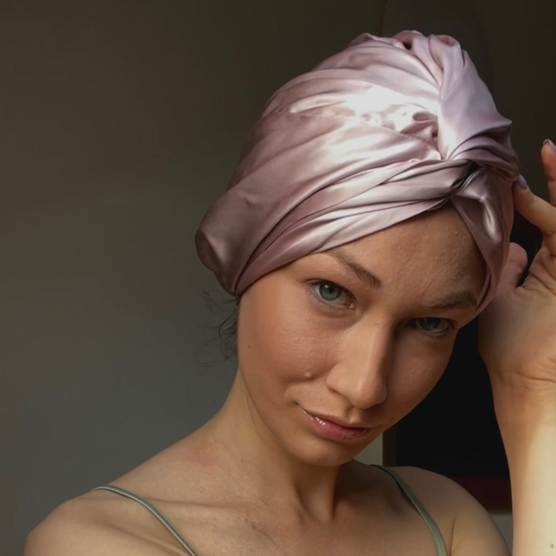 Beautiful woman wearing a 100% mulberry silk hair wrap bonnet turban pink colour