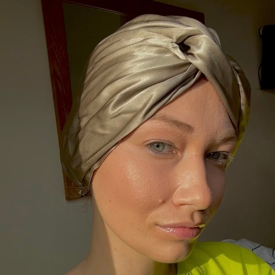 Beautiful woman wearing a 100% mulberry silk hair wrap bonnet turban beige colour (prosecco option)